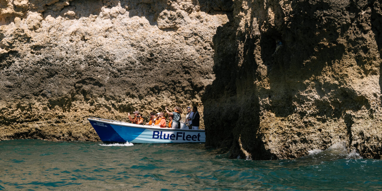 Boat passing a natural arch on the Lagos coast
