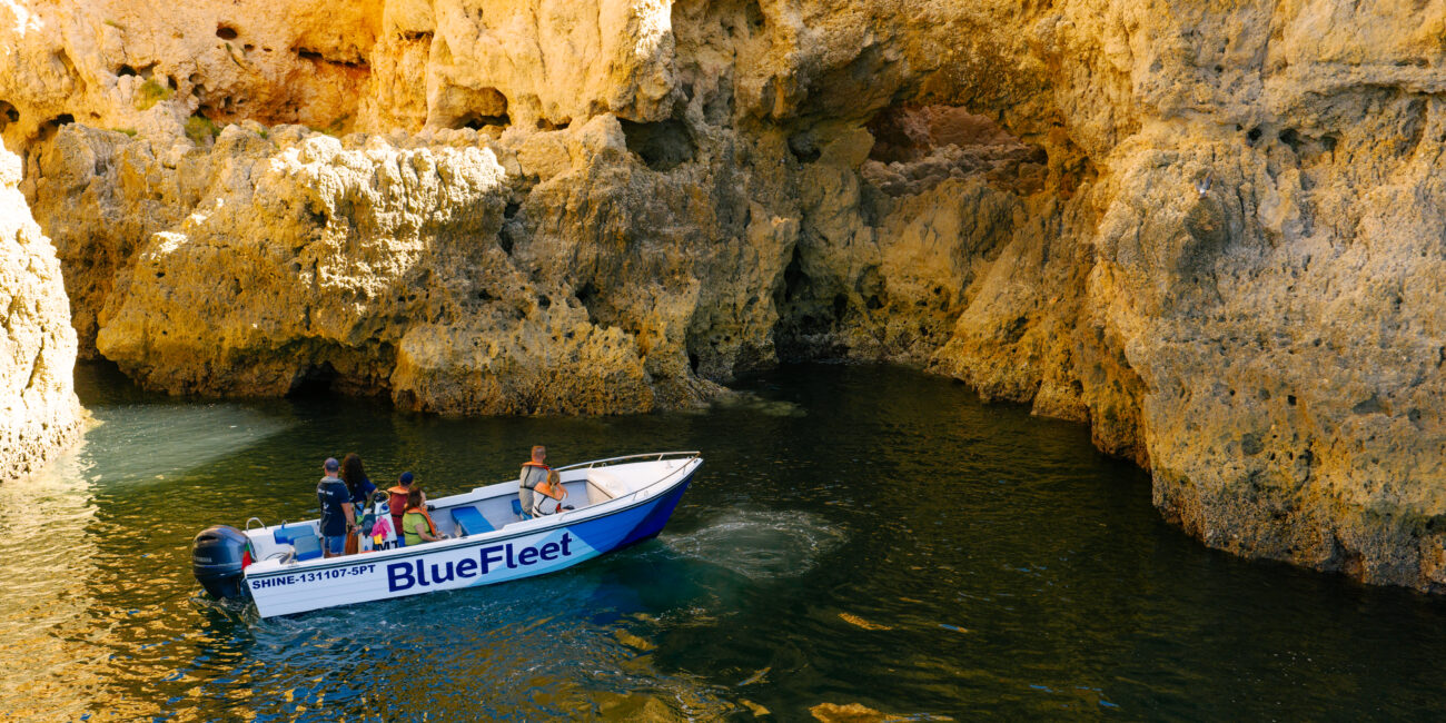 Guests on a small boat among the rock arches of Ponta da Piedade